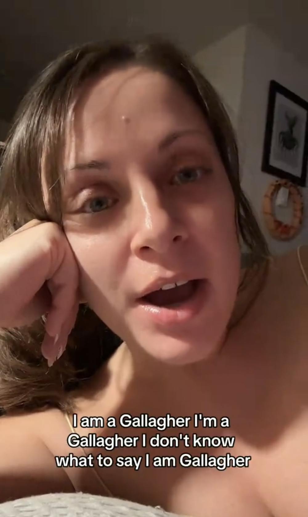 Screenshot of a brunette woman lounging in her house, staring at the camera as she explains, 'I am a Gallagher. I'm a Gallagher I don't know what to say. I am [a] Gallagher.'