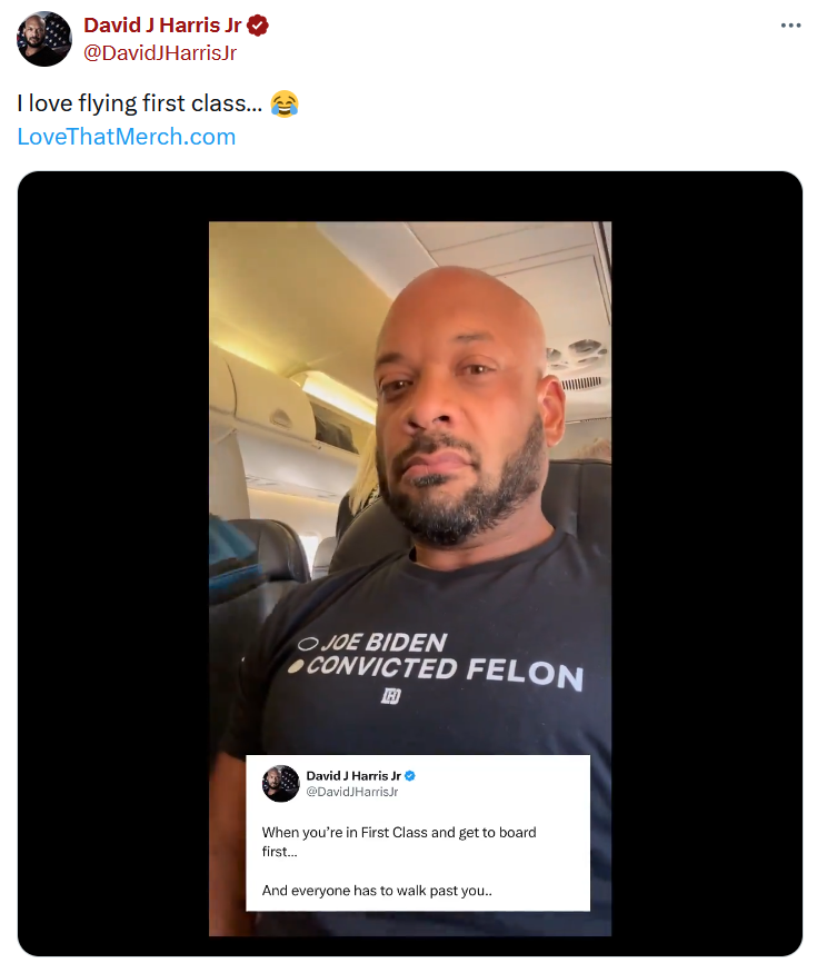 Guy in plane wearing convicted felon shirt original video tweet.