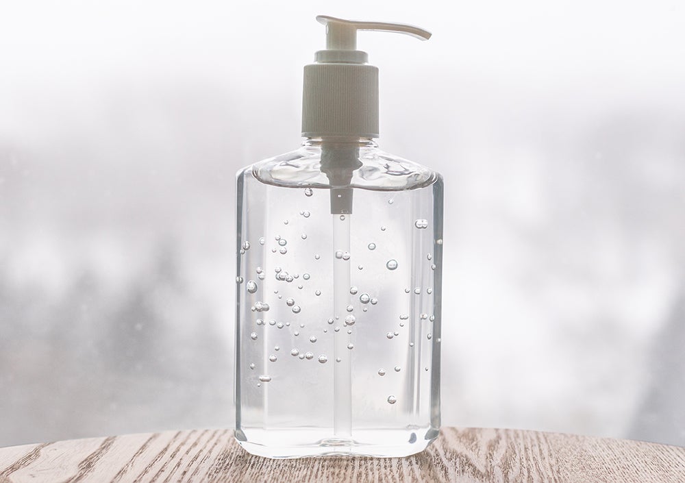 Hand sanitizer bottle on banner header background for COVID-19 Coronavirus concept.