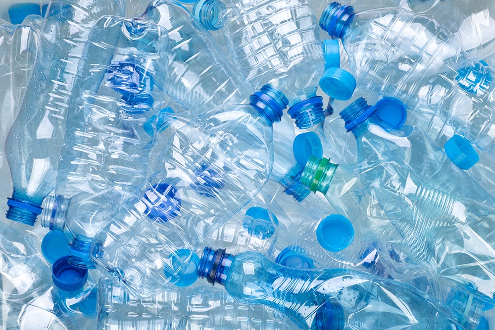 Plenty of plastic bottles on white background top view