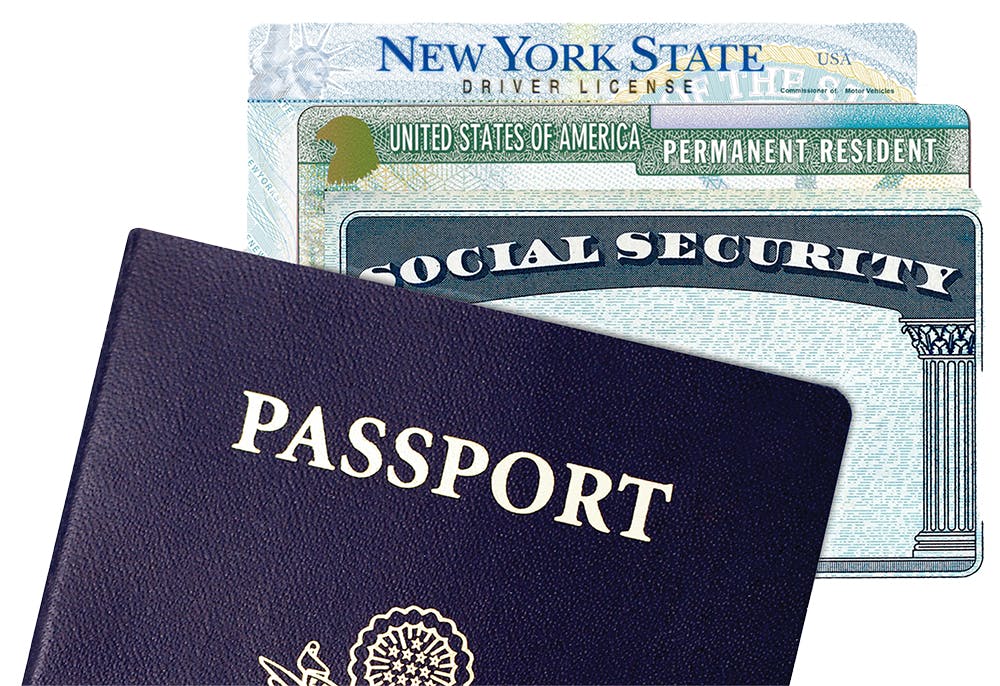 US American Passport, social security card, green card and New York City driver license on isolated background including clipping path.