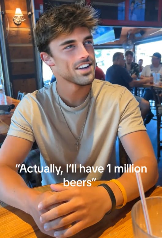 Handsome man saying 'Actually, I'll have 1 million beers.'