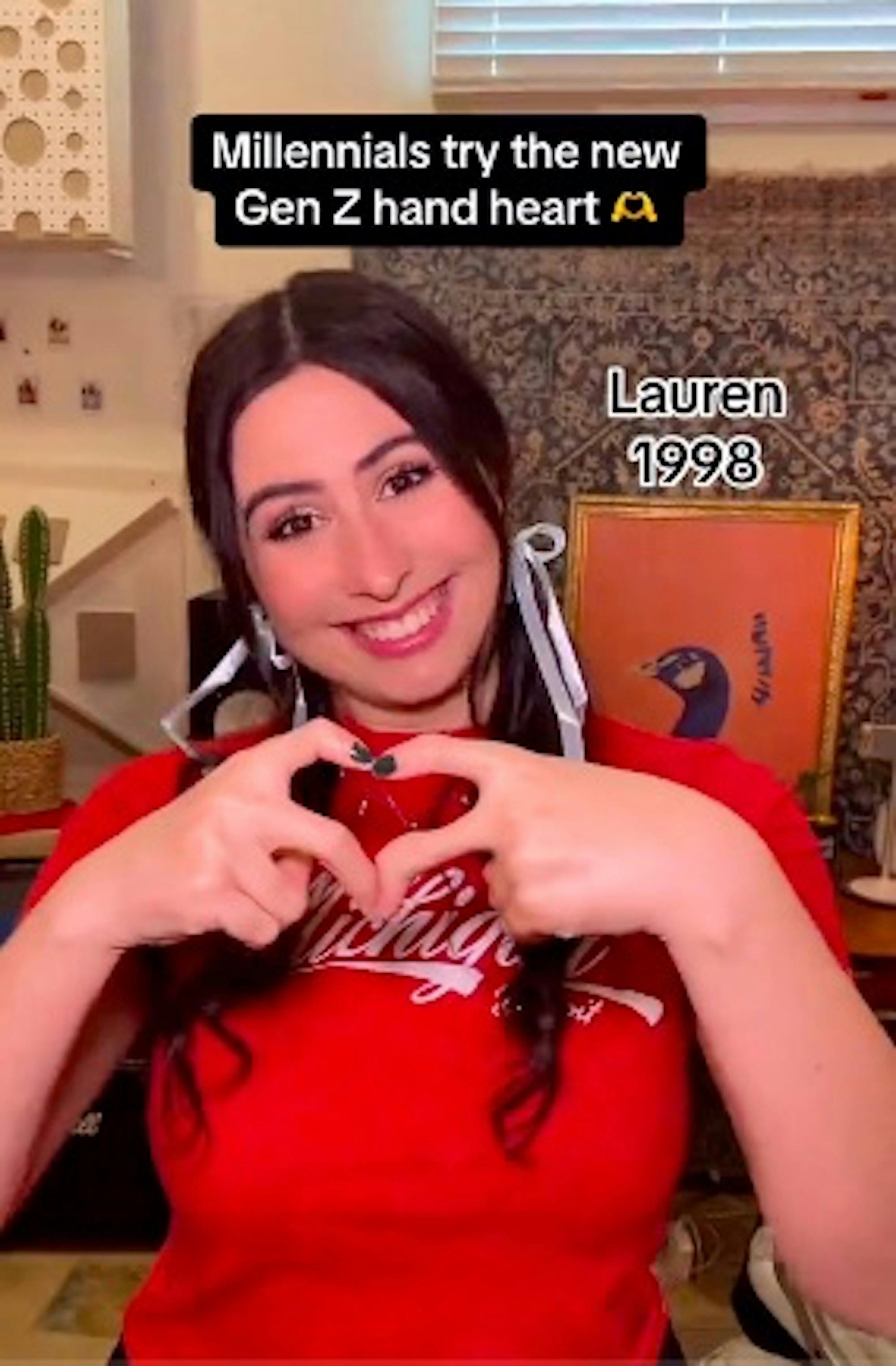 Screenshot from TikTok by @cimorelliband where millennials try to do gen z heart hands