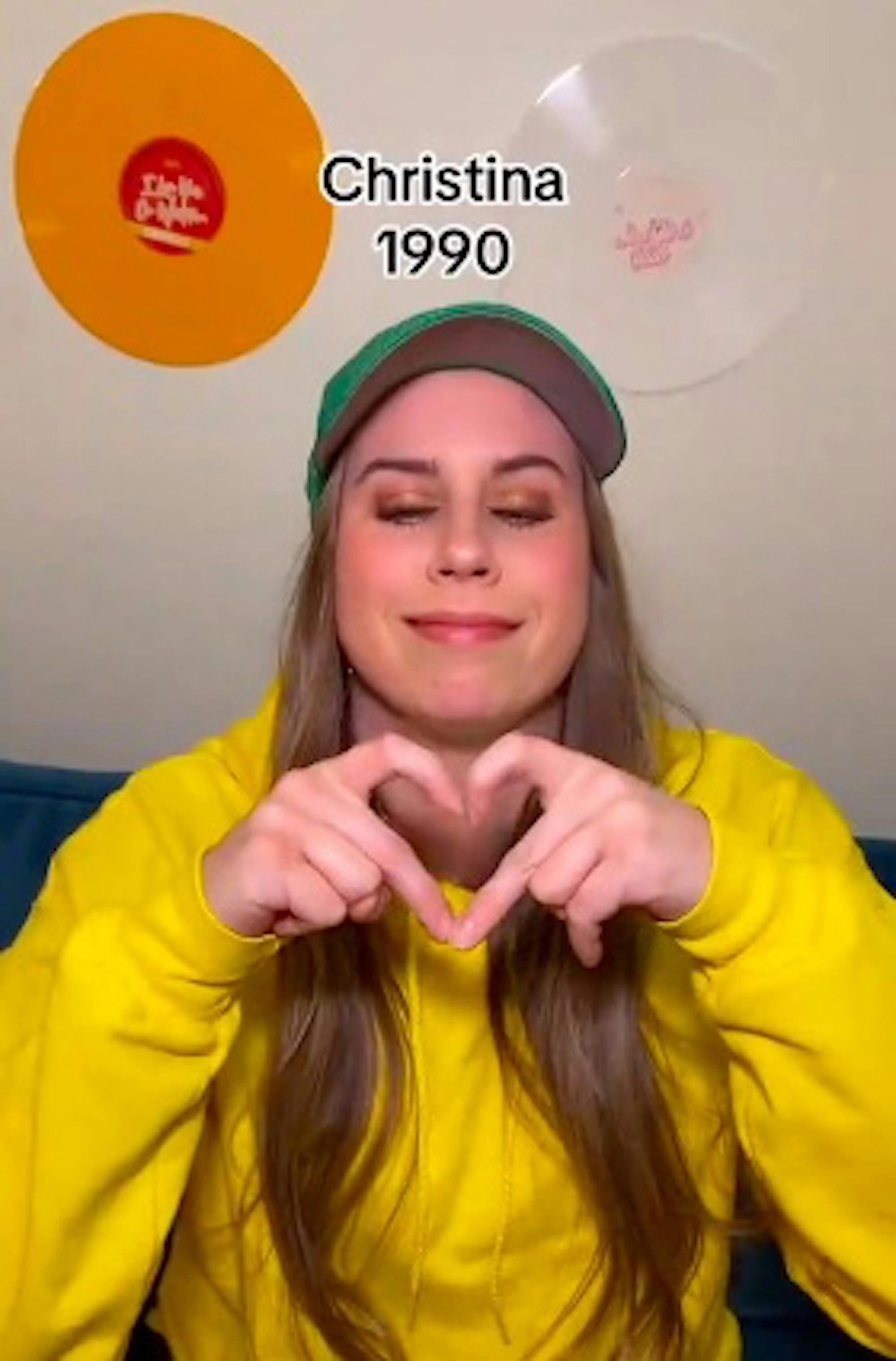 Screenshot from TikTok by @cimorelliband where millennials try to do gen z heart hands