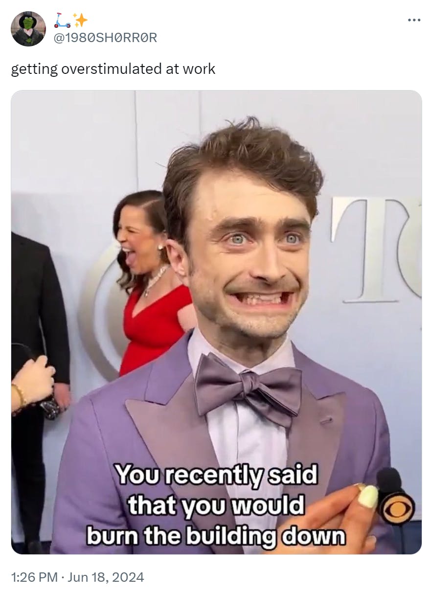 Funny work meme saying, 'getting overstimulated at work.' Attached photo of Daniel Radcliffe looking wide eyed with a purposely-disturbed grin on his face. Text overlay reads, 'You recently said that you would burn the building down.'