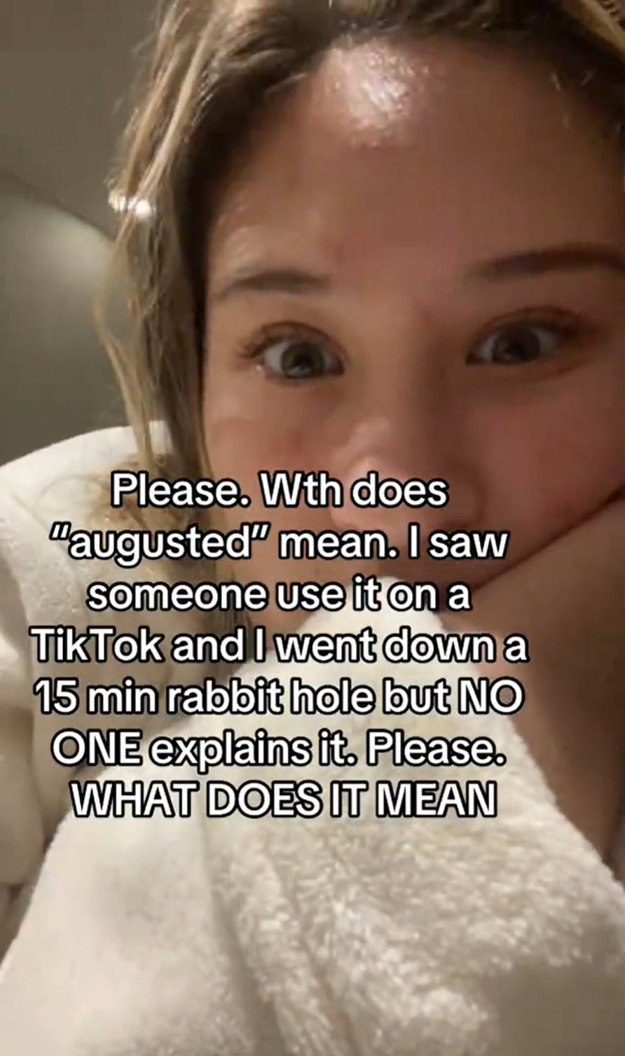 Young woman staring at the camera. Text overlay reads, 'Please. Wth does ‘augusted’ mean. I saw someone use it on a TikTok and I went down a 15 min rabbit hole but NO ONE explains it. Please. WHAT DOES IT MEAN.”