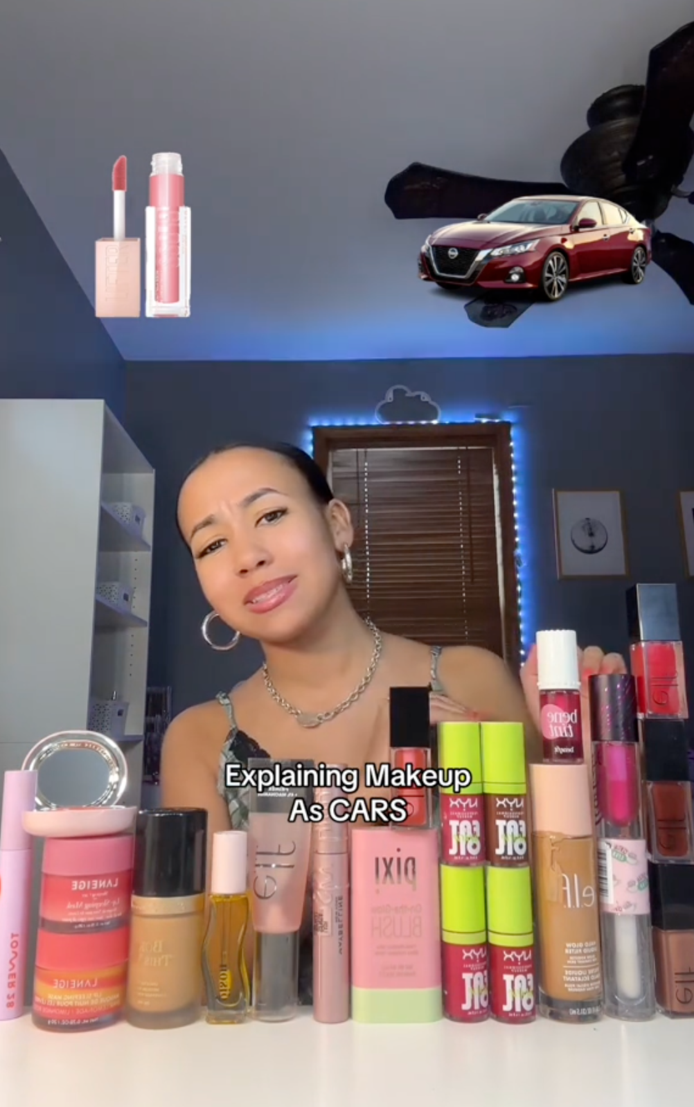 Screenshot of a woman surrounded by makeup products with a photo of a car in the upper right. Text overlay reads, 'Explaining Makeup As CARS.'