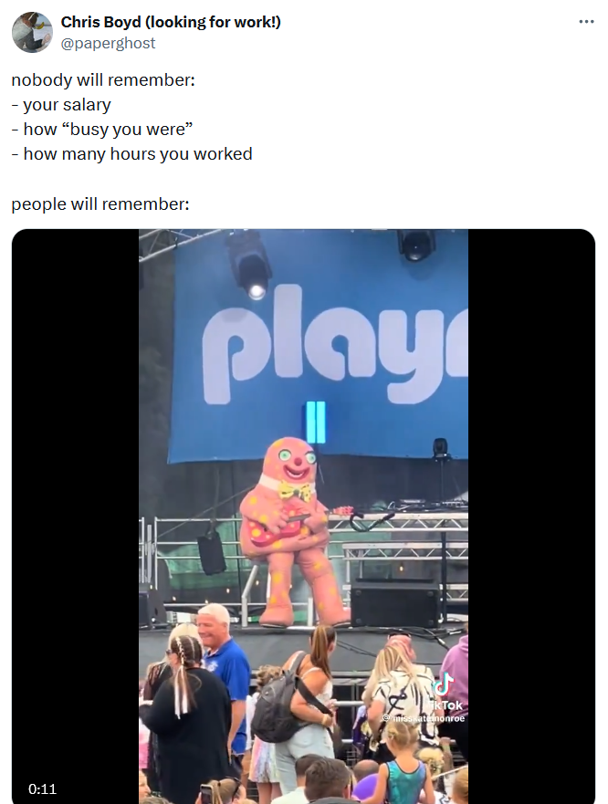 'Nobody will remember' meme with a video of someone in a gingerbread man costume playing guitar on stage.