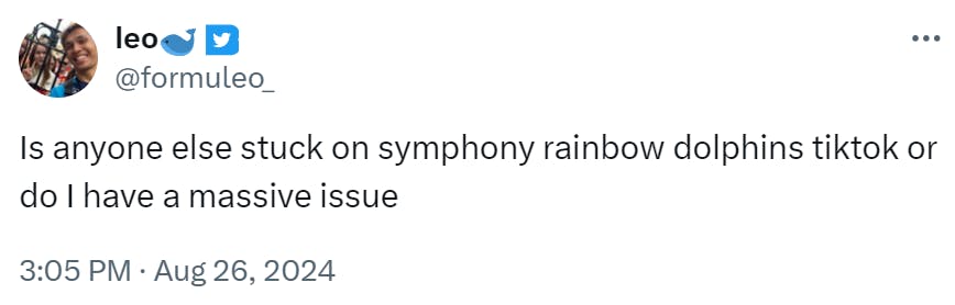 Tweet that reads, 'Is anyone else stuck on symphony rainbow dolphins tiktok or do I have a massive issue.'