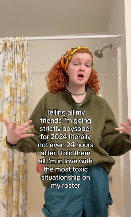 A redhead in slouchy clothing makes a face at the camera. Text overlay reads, 'Telling all my friends I'm going strictly boysober for 2024 literally not even 24 hours after I told them all I'm in love with the most toxic situationship on my roster.'