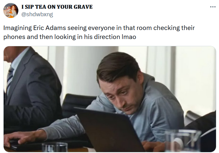 Eric Adams indictment meme with a image of a man slumped over looking at a laptop screen.