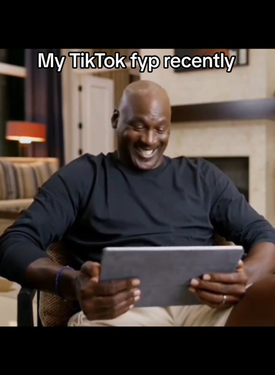 GIFTok video of Michael Jordan giggling at a tablet. Text overlay reads, 'My TikTok fyp recently'