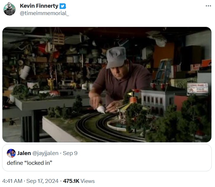 Lock in meme with a photo of a man working on a model train set.