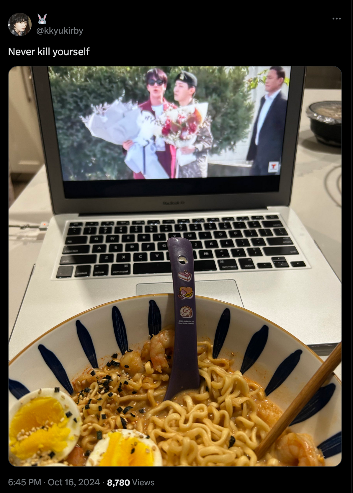 An X post with the caption 'never kill yourself' over a laptop playing a tv program and a large bowl of seemingly homemade ramen.