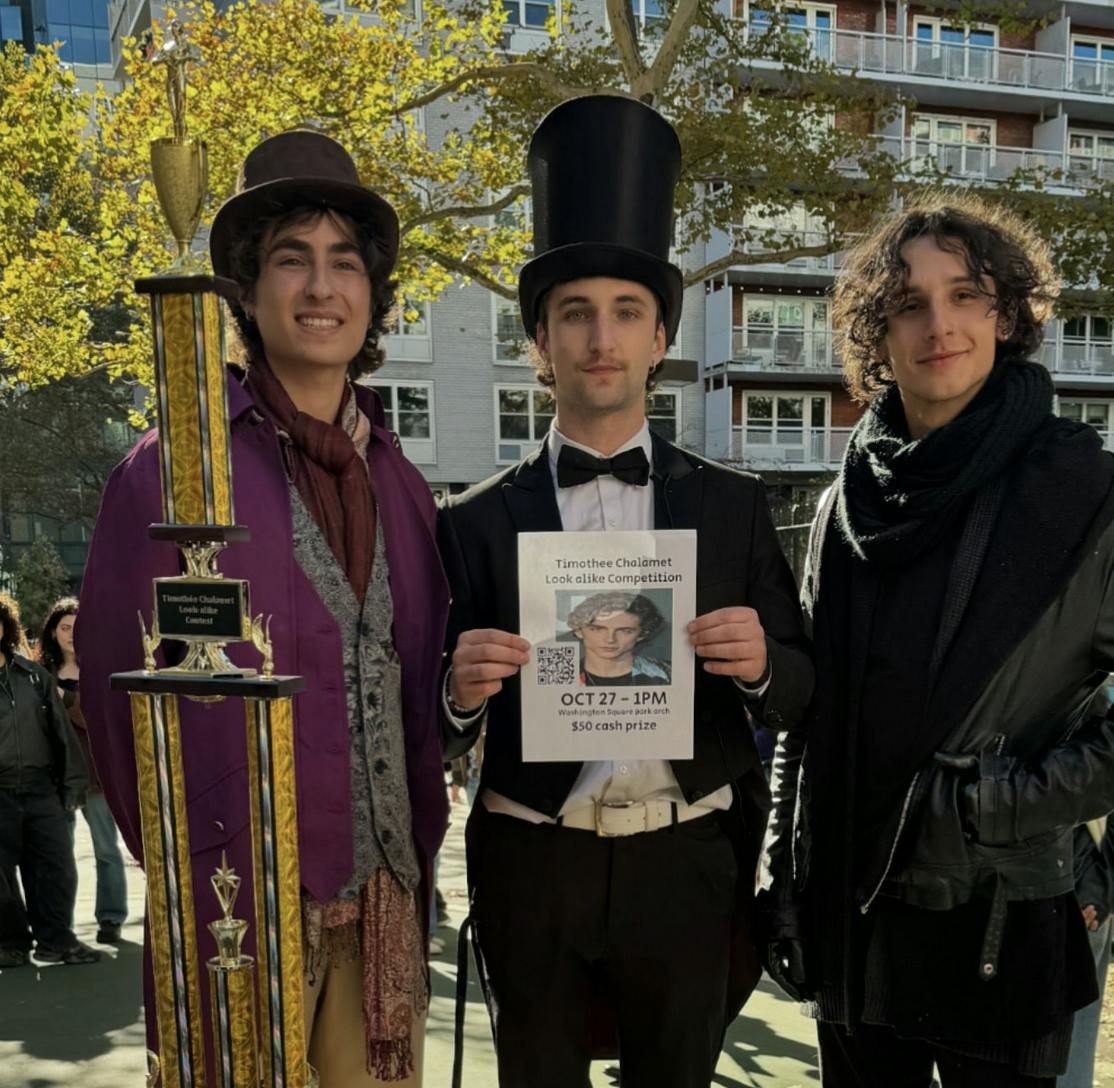 A photo of Anthony Po, two Timothee Chalamet look-alikes, and a giant tropy. Po is holding up his original flier.