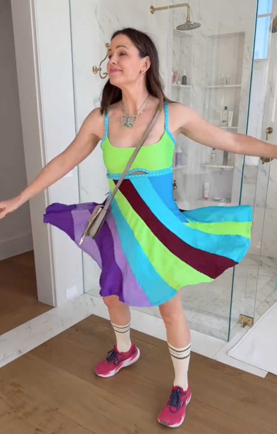 Jennifer Garner twirling around in a multicolored dress in her bathroom