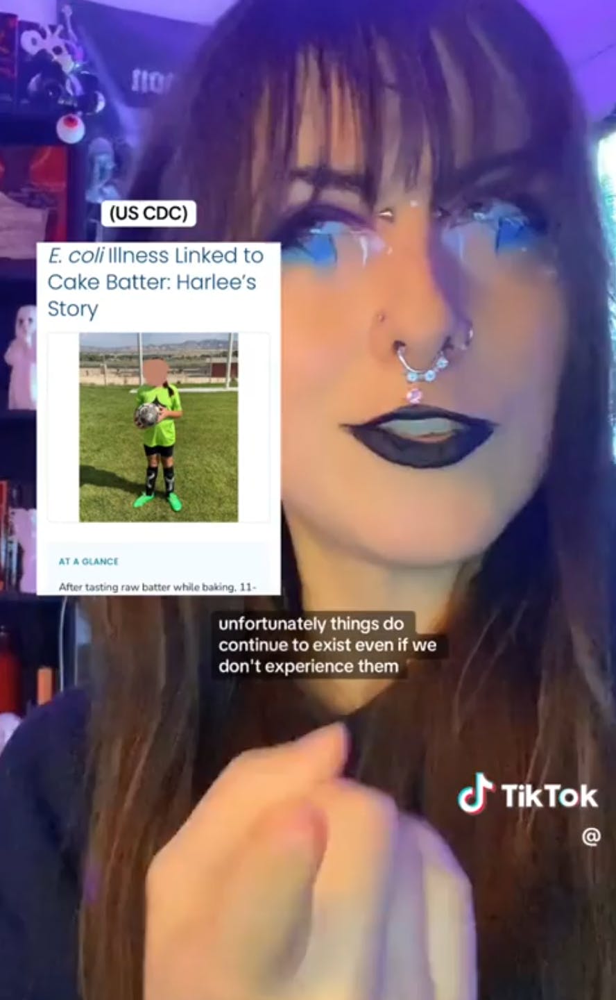 A microbiologist with intense eye makeup warning people against trying the fluffy popcorn TikTok trend. Text overlay reads, 'unfortunately things do continue to exist even if we don't experience them.'