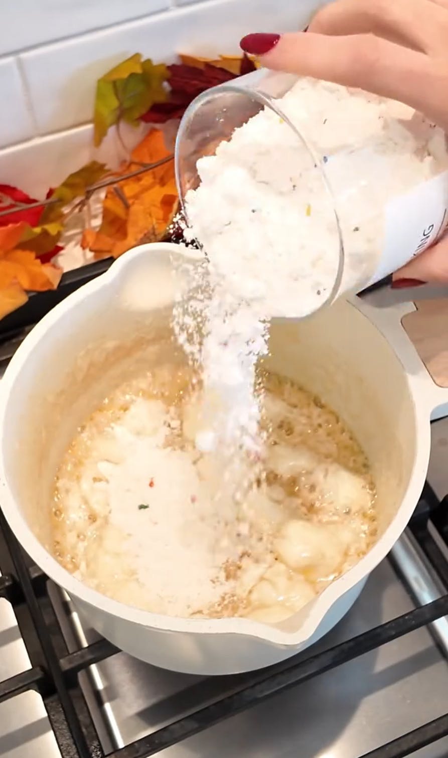 Fluffy popcorn trend on TikTok, the cook putting raw flour into their saucepan.