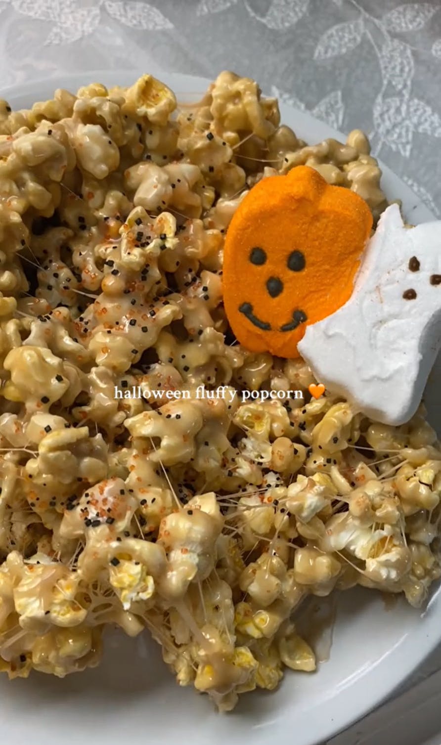 Fluffy popcorn trend on TikTok, Halloween edition with pumpkin and ghost peeps on the plate.