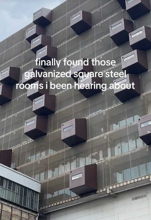 TikTok video showing metal boxes jutting out from an apartment building.