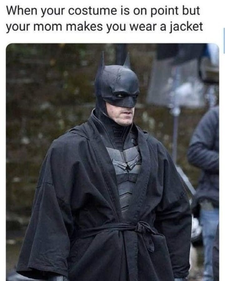 Halloween meme text reads, 'When your costume is on point but your mom makes you wear a jacket.' with a photo of Batman in a black robe.