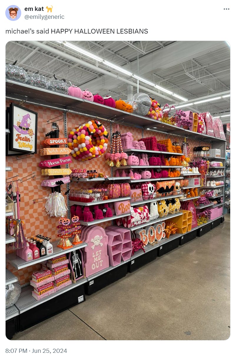 Tweet that reads, 'michael's said HAPPY HALLOWEEN LESBIANS.' with a photo of lesbian flag color-themed Halloween decorations.