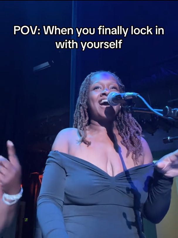 I'm Locked In With Myself TikTok video showing a woman smiling while singing into a mic.