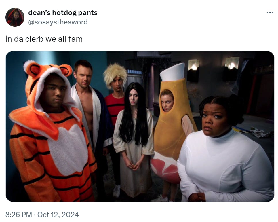 in da clerb we all fam meme featuring the cast of Community dressed up in Halloween costumes.