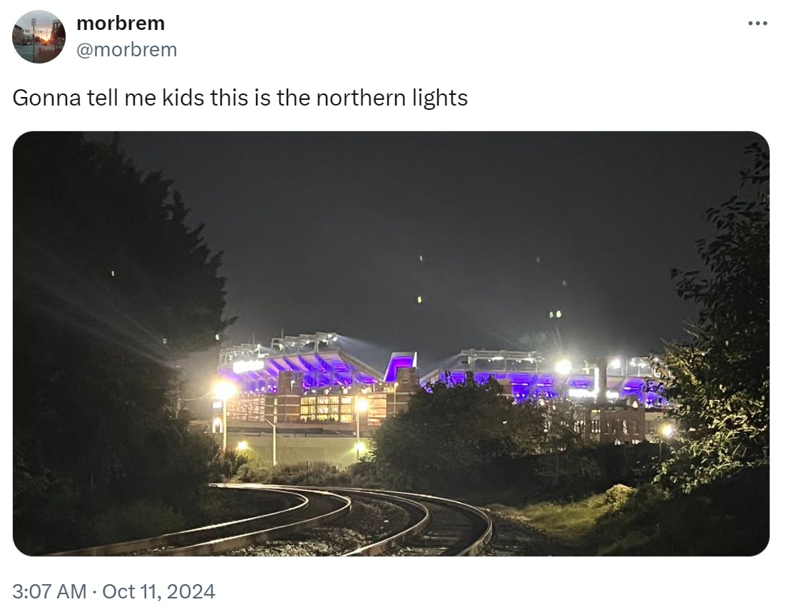 Tweet that reads, 'Gonna tell me kids this is the northern lights.' with a photo of a stadium at night.