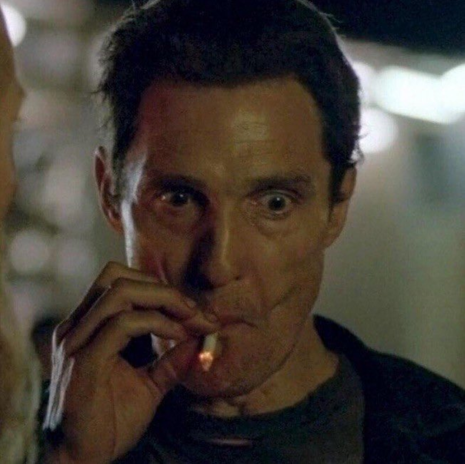 A photo of matthew mcconaughey smoking a cigarette intensely