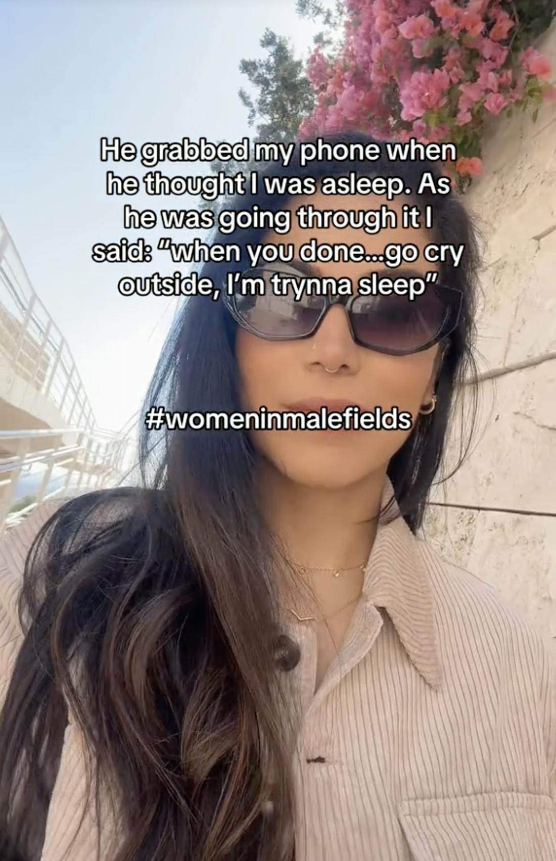 A TikTok video of a woman walking smiling, 'he grabbed my phone...etc. #Womeninmalefields'