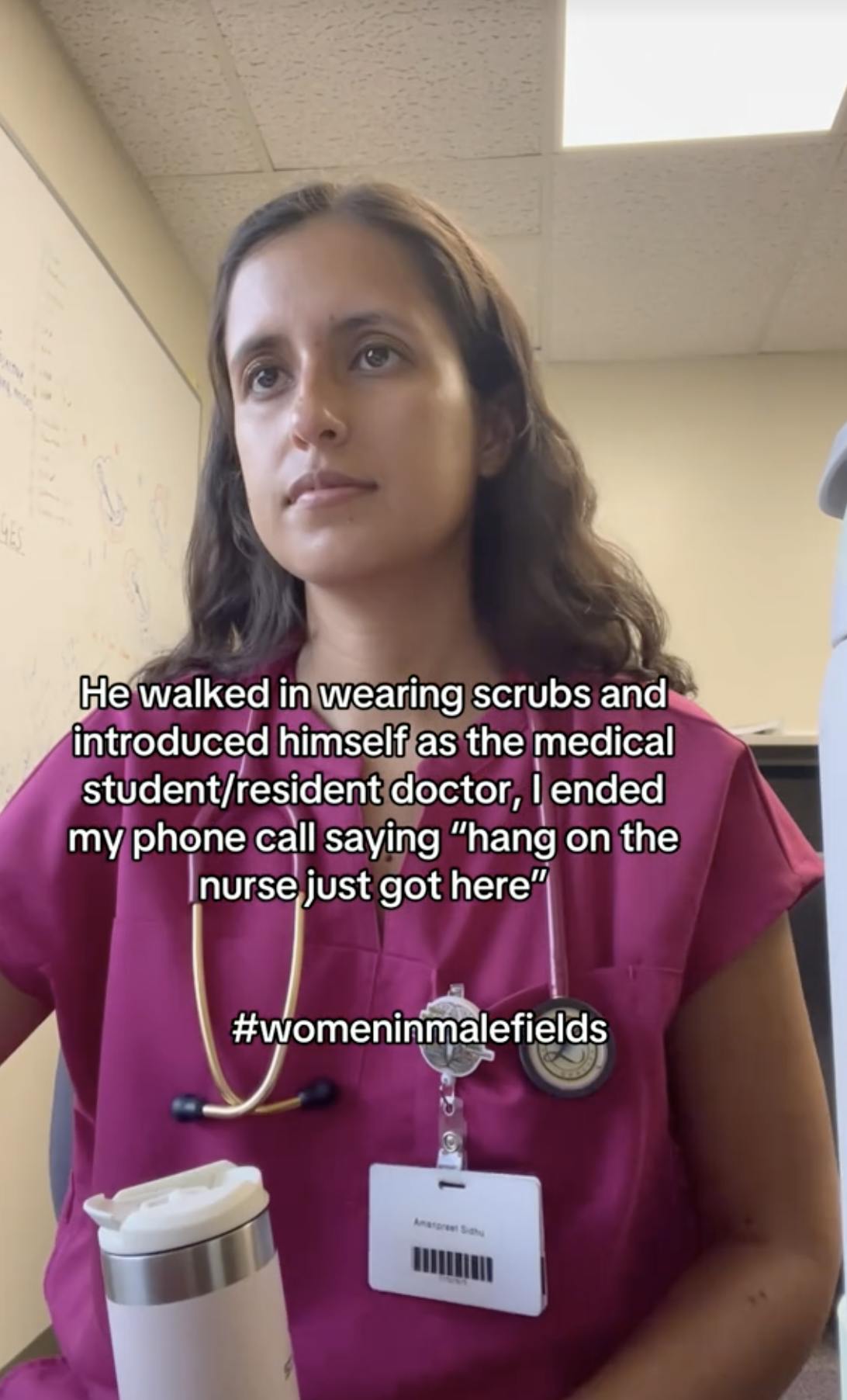 A TikTok video of a doctor in her scrubs, working on a computer. The caption is about a man being mistaken for a nurse in the hospital, ending with #Womeninmalefields