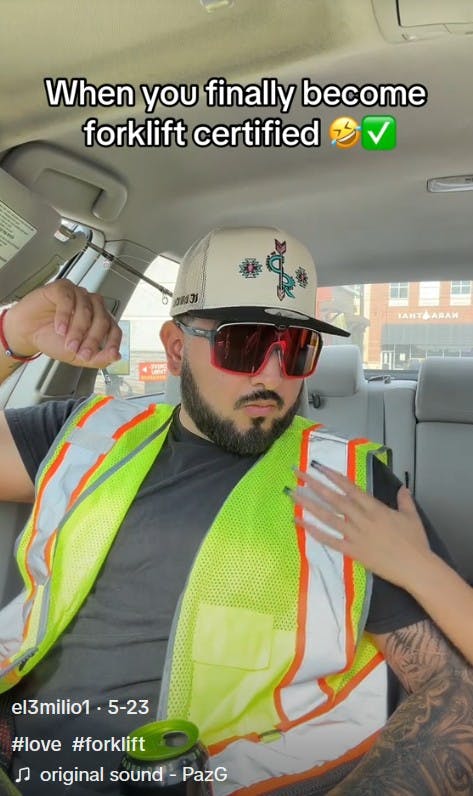 woman rubbing man in construction vest's chest