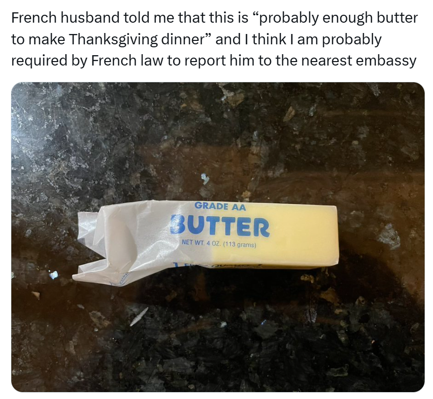 Funny Thanksgiving meme, text reads, 'French husband told me that this is 'probably enough butter to make Thanksgiving dinner' and I think I am probably required by French law to report him to the nearest embassy' with a photo of half a stick of butter.