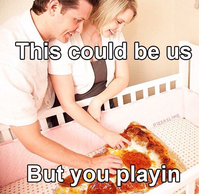 couple taking care of a slice of pepperoni pizza in a crib with caption 'this could be us but you playin'