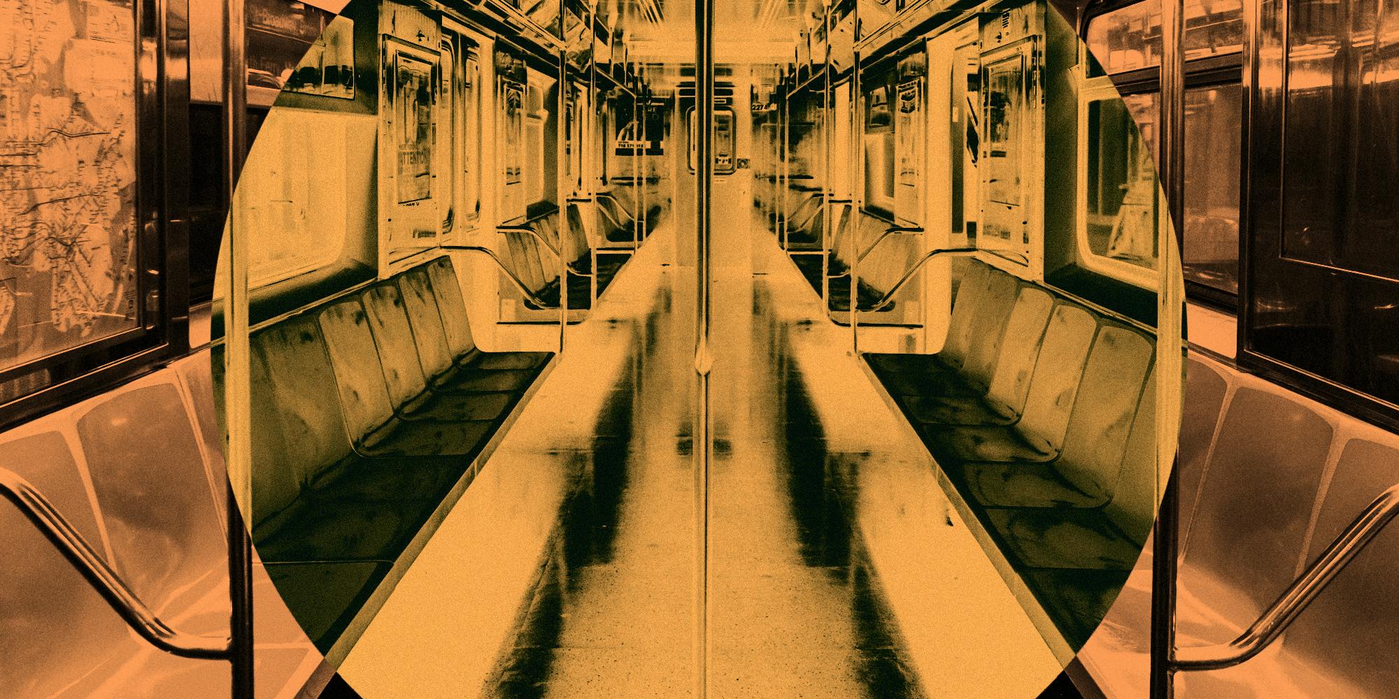 Empty subway car with orange seats and metal poles.