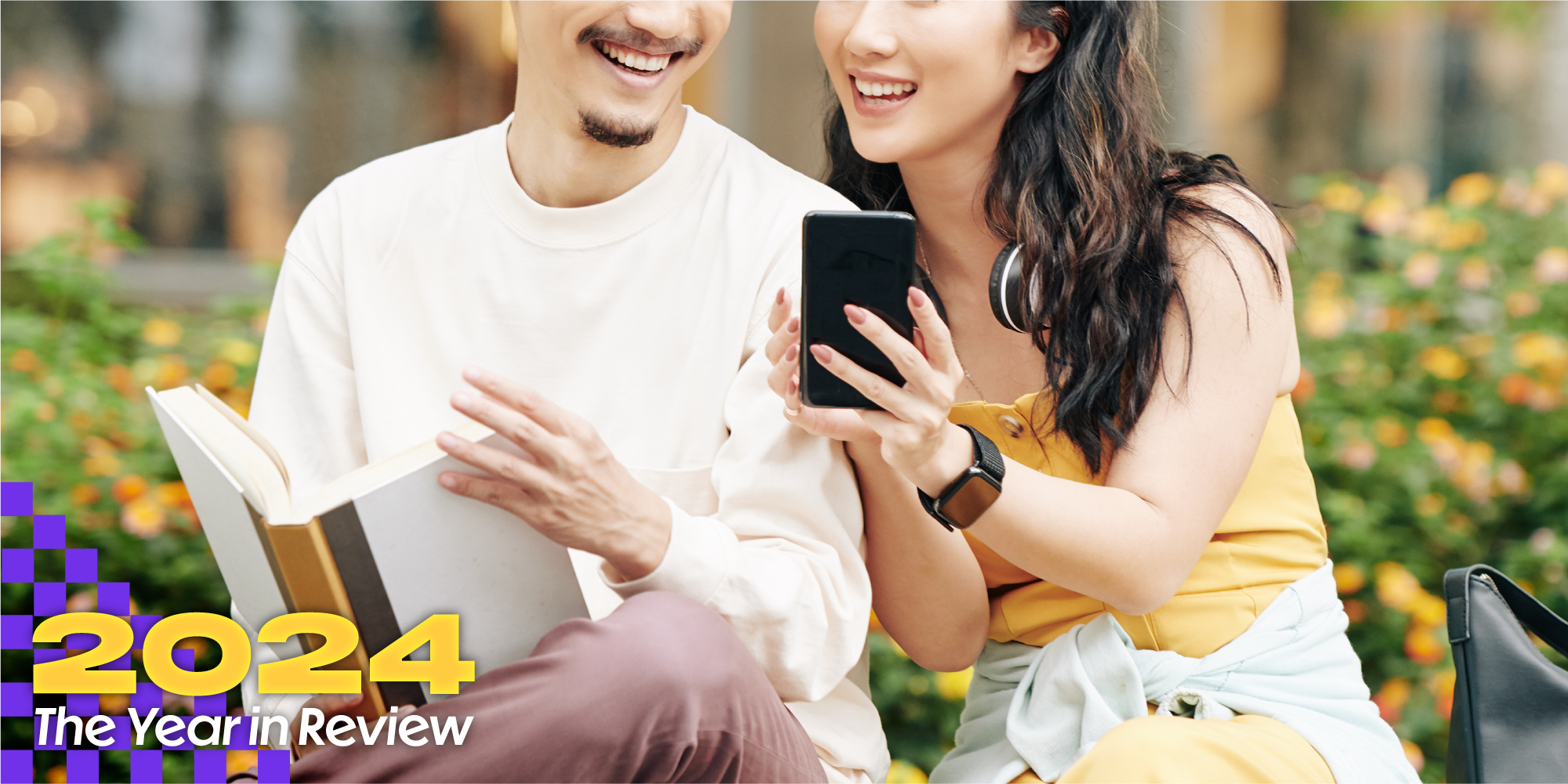 Two people look at a phone together and smile. Text over says, '2024, The Year in Review.'