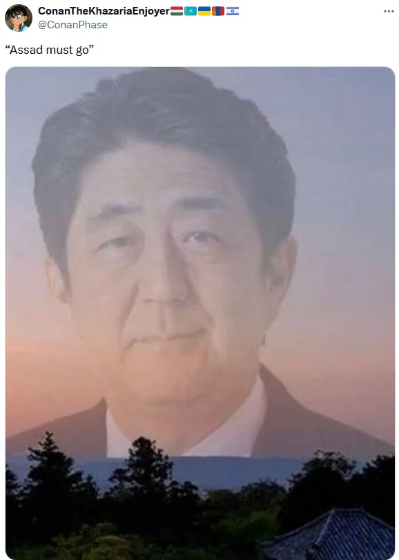 Assad Must Go meme with a transparent image of Shinzo Abe over a sunset.