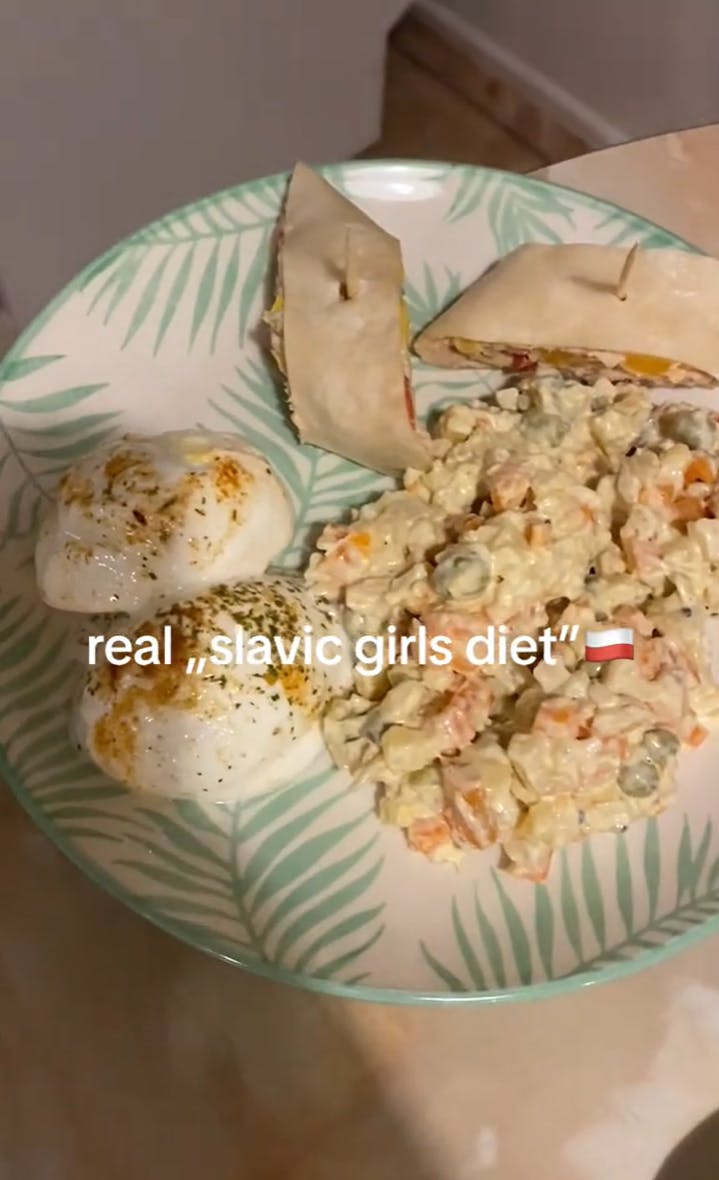 Still of a TikTok with text overlay reading, 'real 'slavic girls diet'' with rich and fatty foods on a plate.