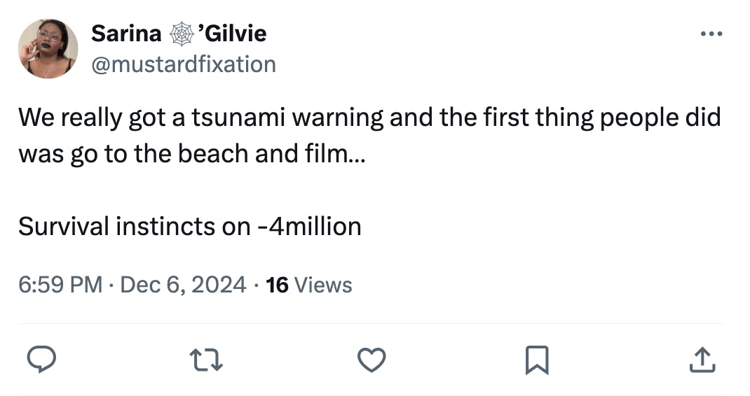 Tweet that reads, 'We really got a tsunami warning and the first thing people did was go to the beach and film… Survival instincts on -4million'