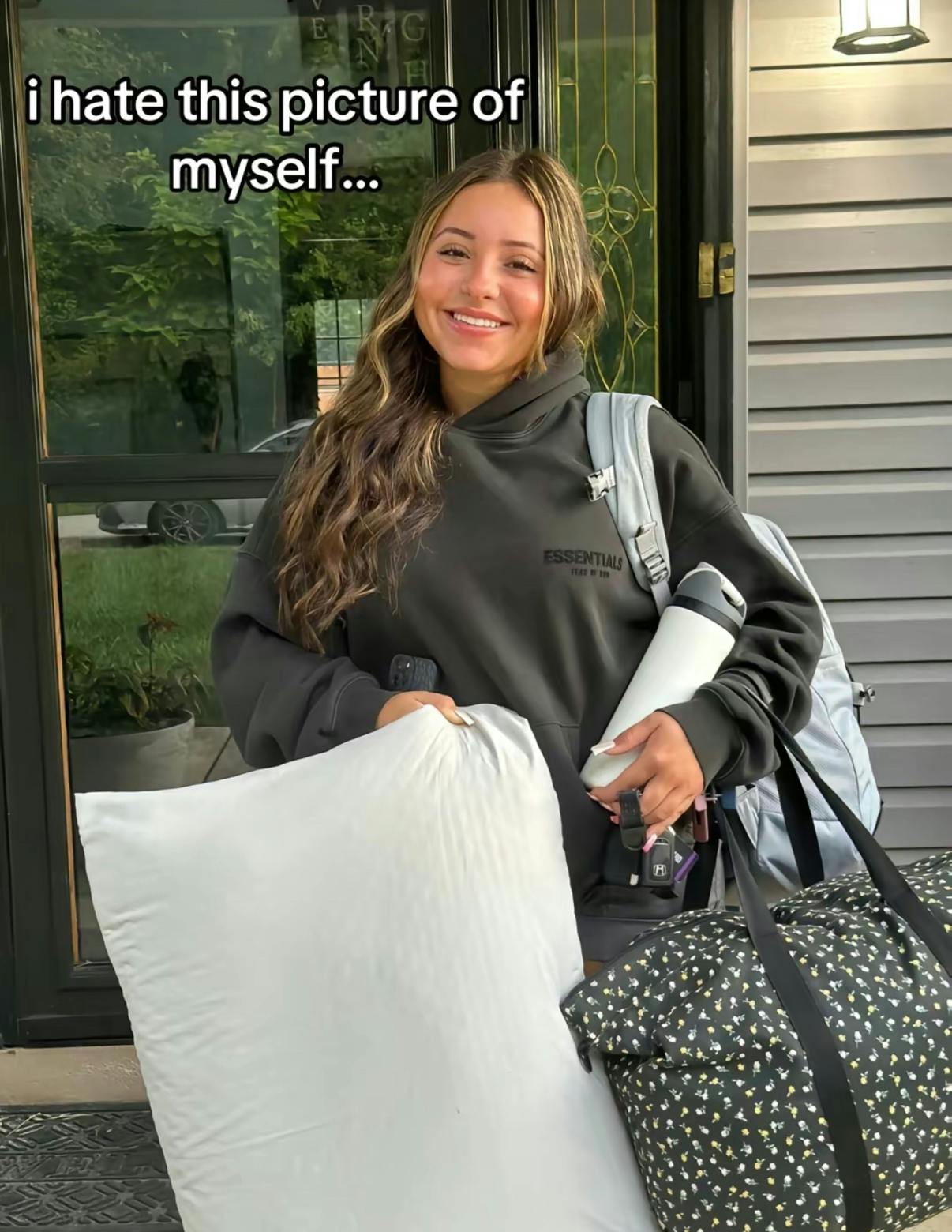 TikTok photo of a young woman smiling for the camera. Text overlay reads, 'I hate this picture of myself...'