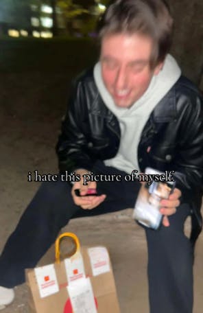 TikTok photo of a college guy eating McDonalds. Text overlay reads, 'I hate this picture of myself.'