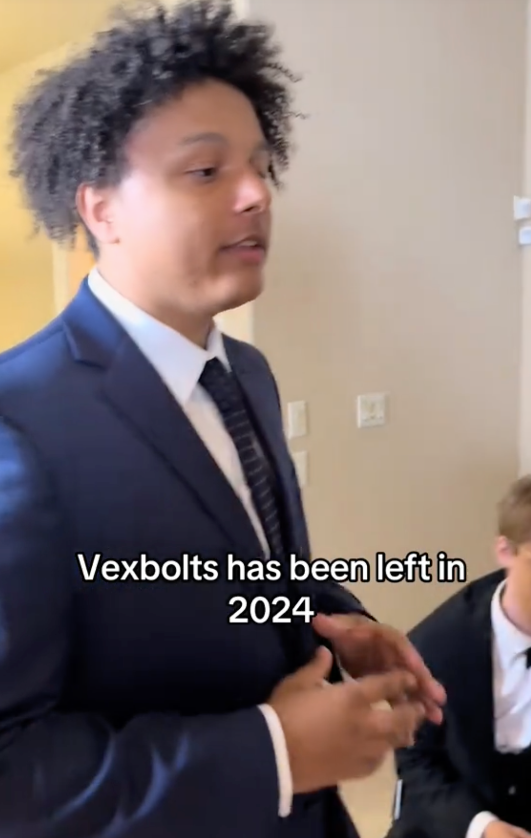 Vexbolts in a suit, walking around a funeral parlor talking about his unfollowing