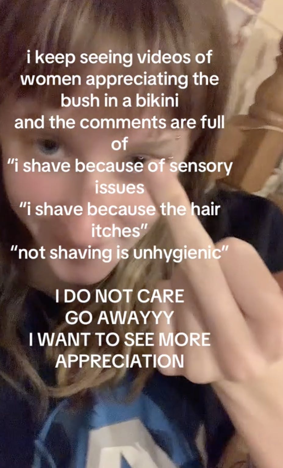 A woman on TikTok raising her middle finger and demanding full bush appreciation