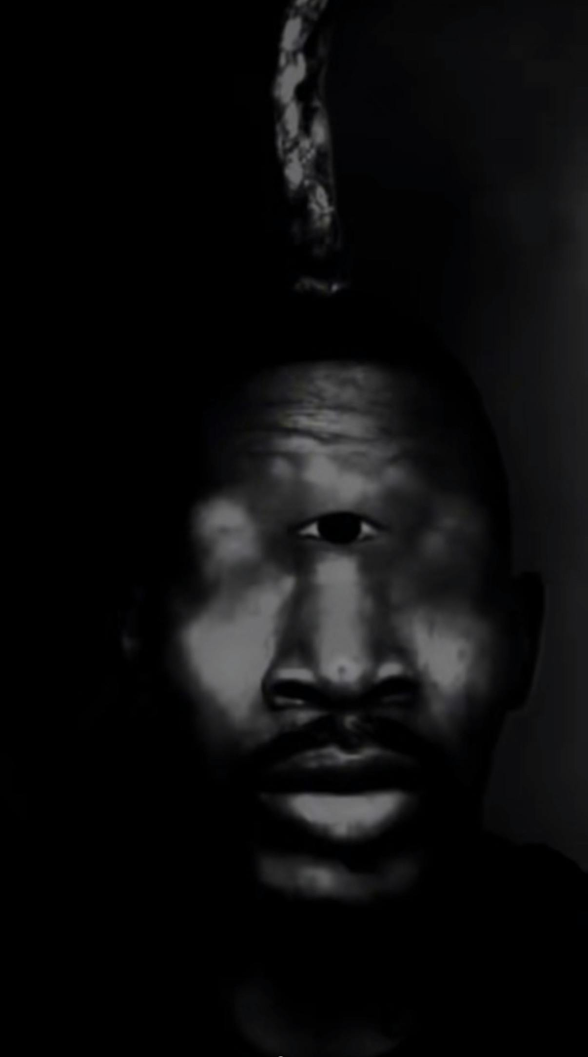 Eye of Rah meme edit of a black man turned into a cyclops, in a dark black and white gradient.