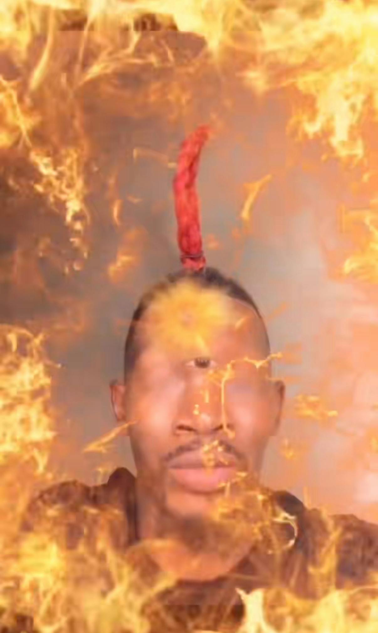 Eye of Rah meme edit with a Black man, his eye in the middle of his forehead with fire all around him.