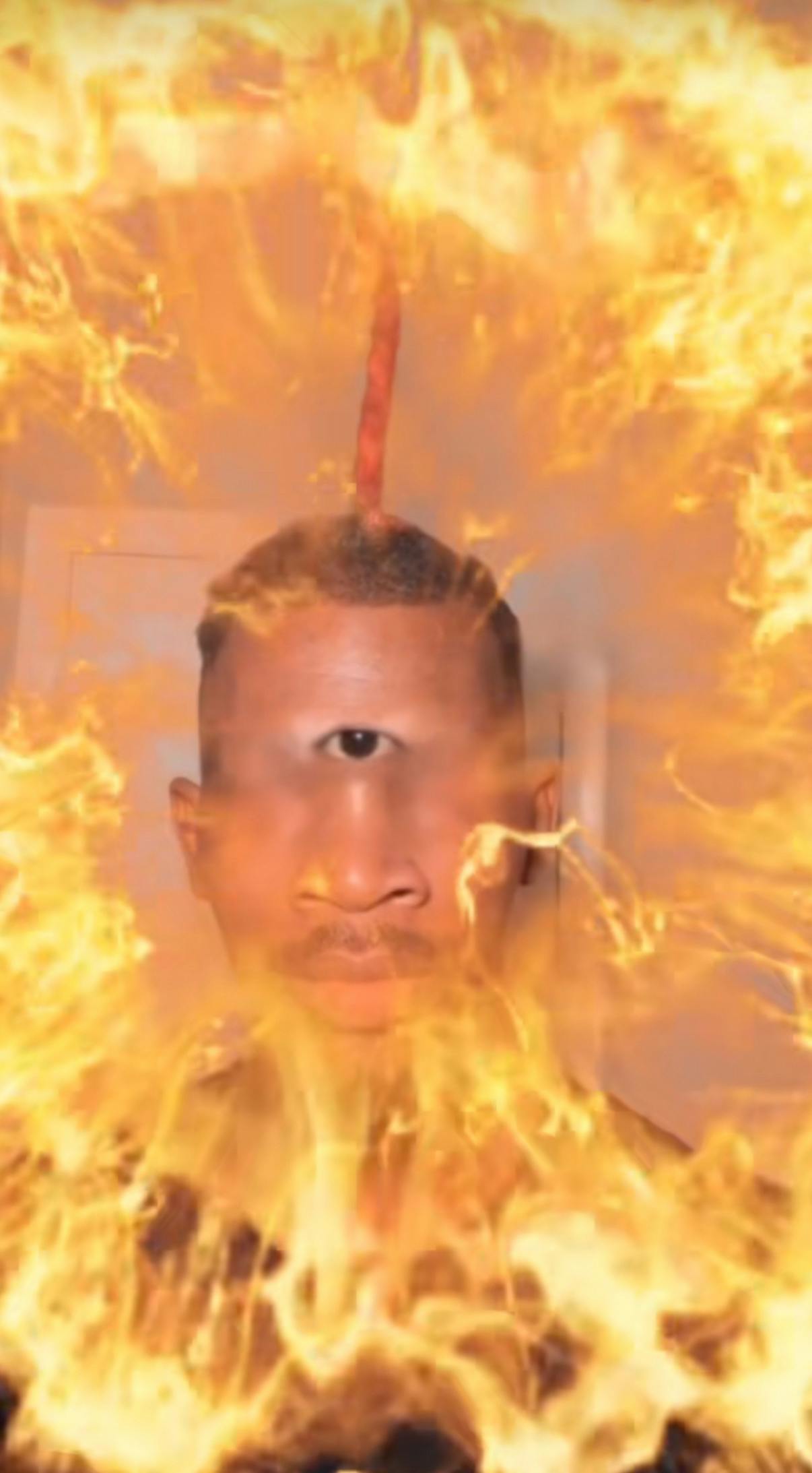 Eye of Rah meme edit with a Black man, his eye in the center of his forehead with fire all around him.