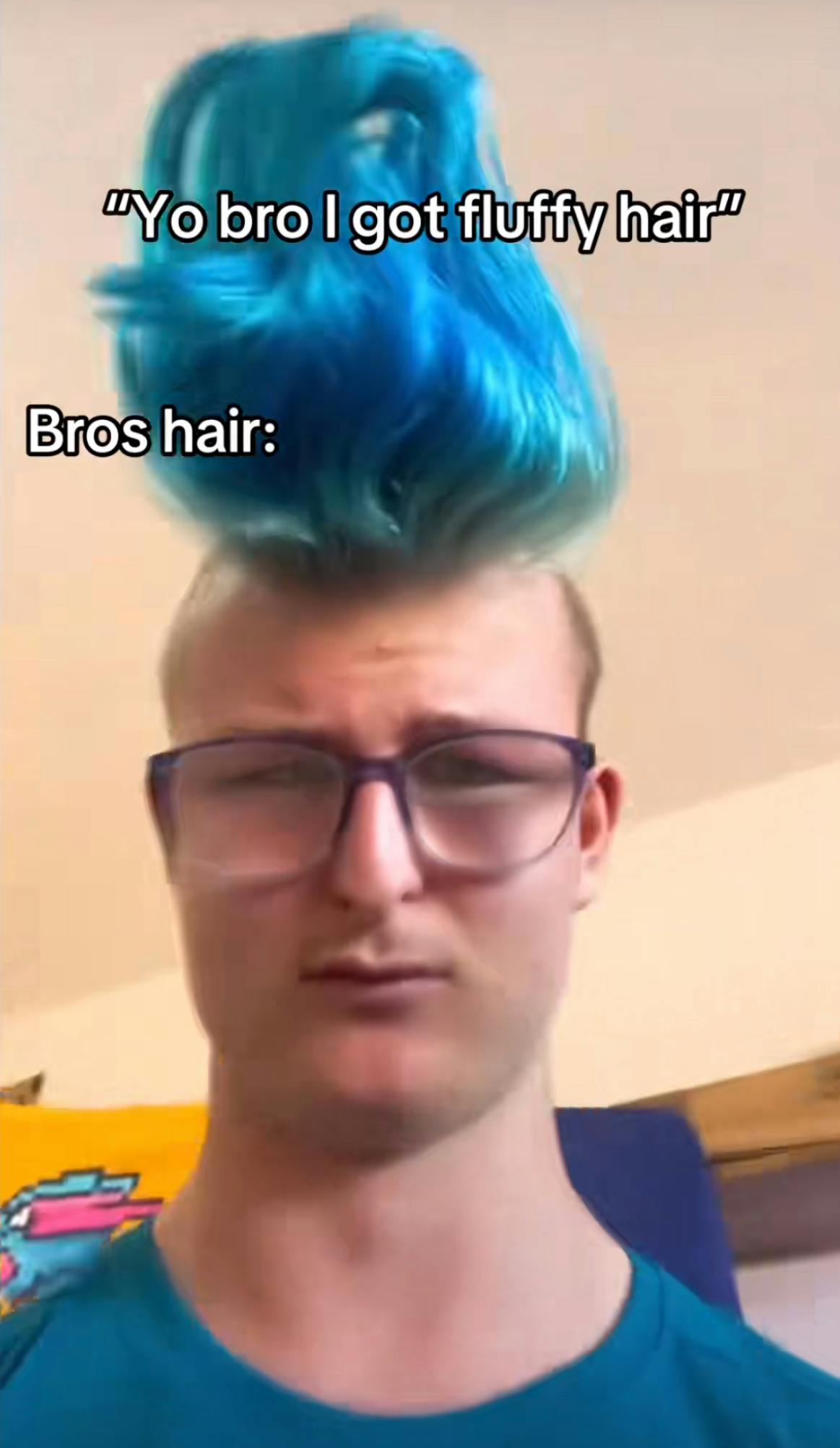 Screenshot of a young man with bright blue hair sticking up in a wave from his head because of how much product he has in it. Text overlay reads, ''Yo bro I got fluffy hair' Bros hair:'