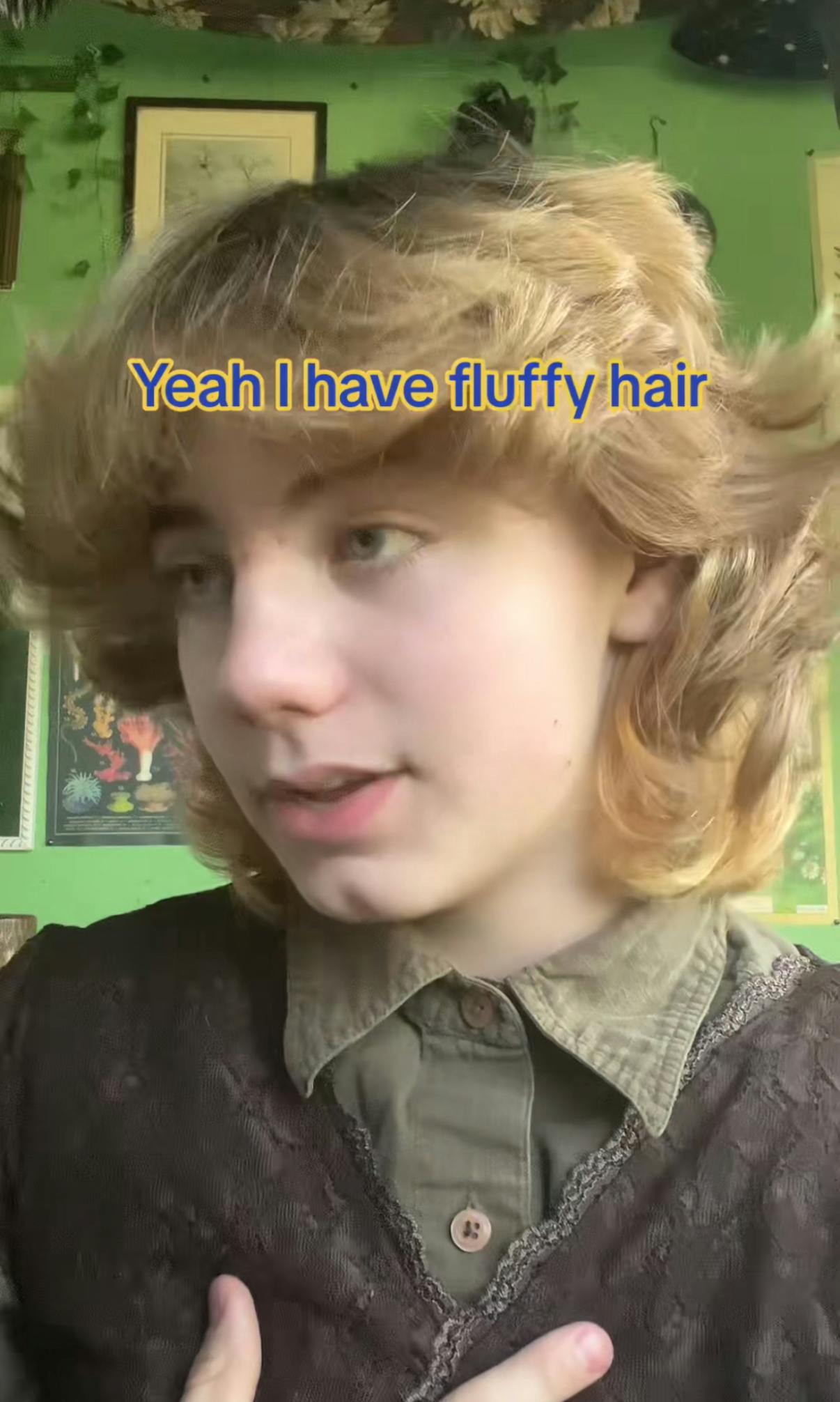 Screenshot of a young man with a fully head of hair 'talking' to someone off-camera saying, 'Yeah I have fluffy hair.'