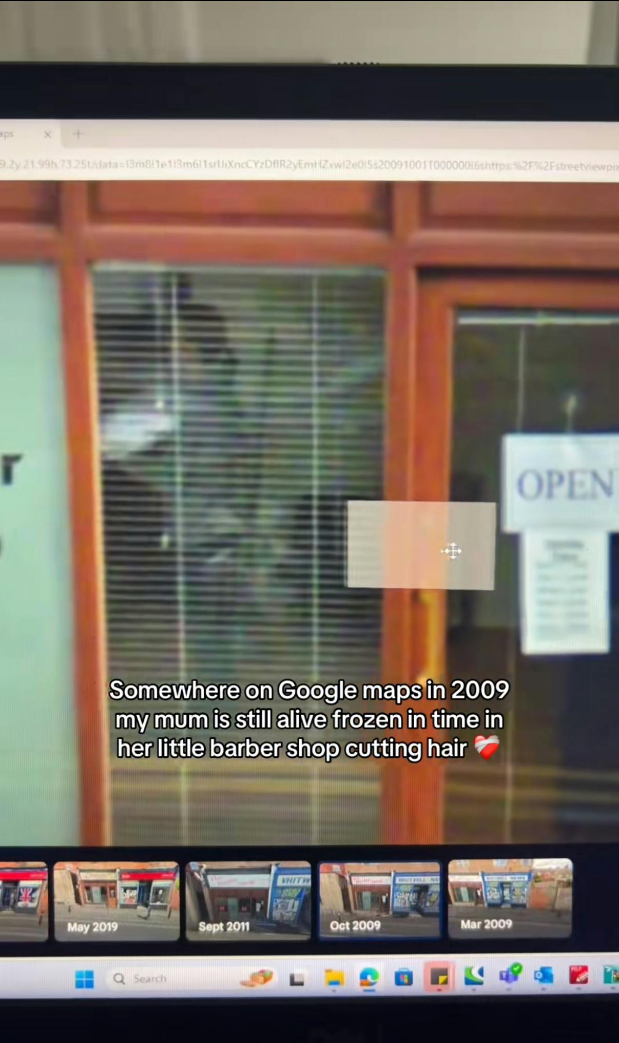 Somewhere on Google trend screenshot of a woman inside a barber shop. Text overlay reads, 'Somewhere on Google maps in 2009 my mum is still alive frozen in time in her little barber shop cutting hair. (broken heart emoji)'